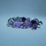 Lumoola beaded bracelet featuring amethyst and clear quartz, symbolizing soothing frequencies that calm sensory overload, inspired by the brand's support for autism awareness.