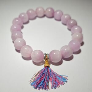 Lumoola Purple Lithium Brilliance bracelet featuring light purple beads and a multi-colored tassel. This gemstone is used to ignite passion for the Fire Element in Feng Shui and bring calming energy to the Crown Chakra.